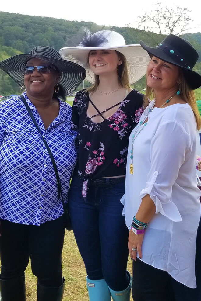 COMSO women sporting fancy hats at Legacy Chase.